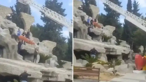 Tatile geldi, yapay şelalenin tepesinde mahsur kaldı